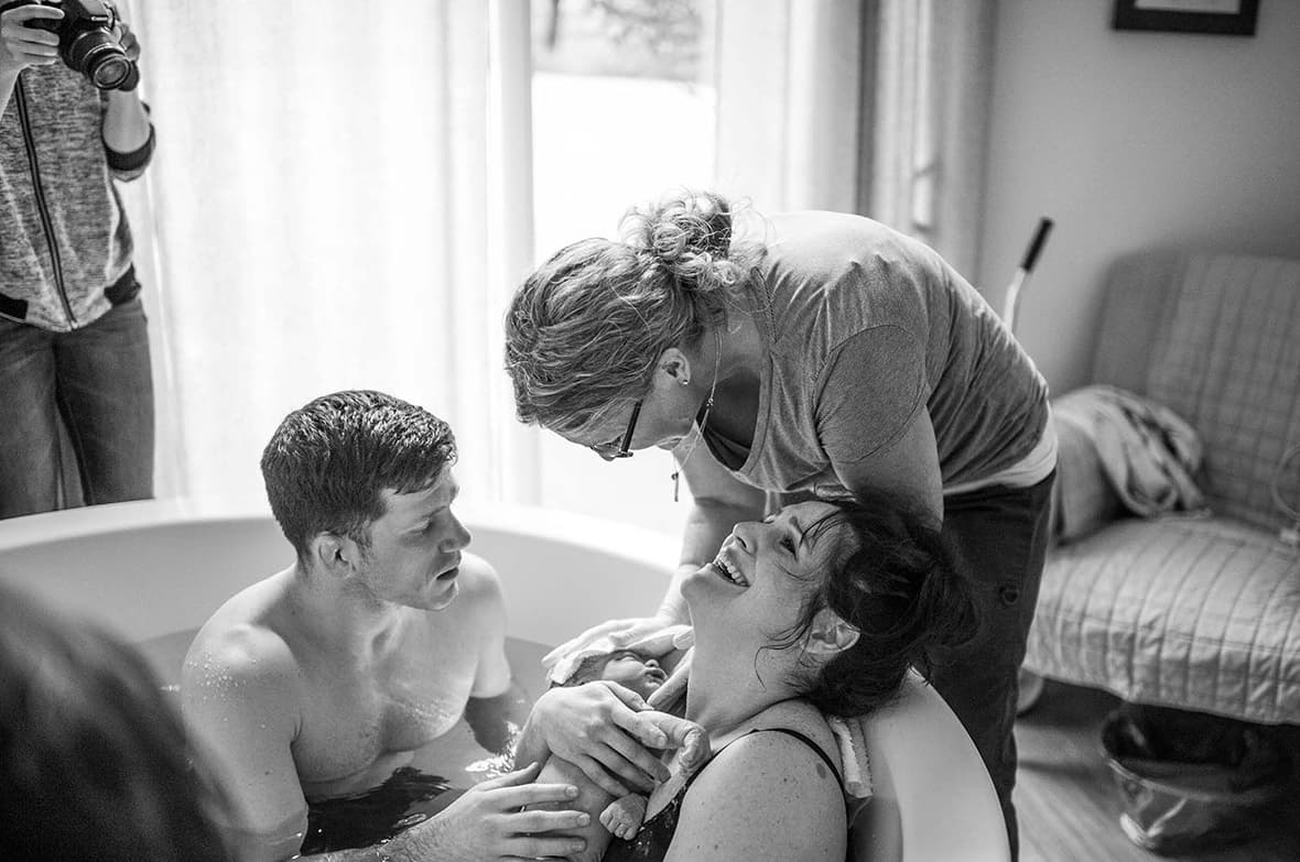 Pregnant woman man booking tour for The Birthing Inn.